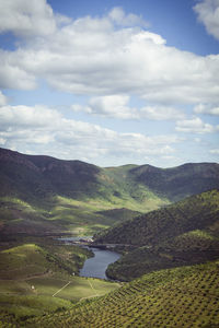Scenic view of lake and mountains against sky