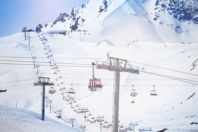Ski lift over snow covered mountains