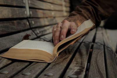 Close-up of hand holding open book