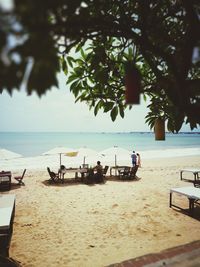 People on beach against sky