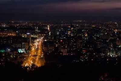 High angle view of illuminated buildings in city at night