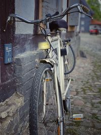 Bicycle parked on street by old building