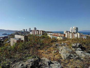 Buildings in city against clear sky