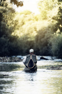 Man fishing in lake at forest