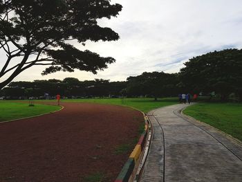 Road amidst trees against sky