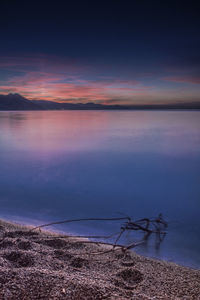 Scenic view of sea against dramatic sky during sunset