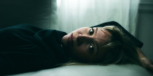 Portrait of woman lying down at home