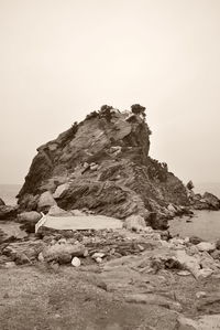 Rock formations on mountain against clear sky