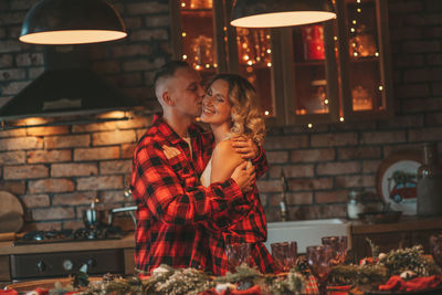 Candid authentic happy married couple spends time alone at lodge xmas decorated