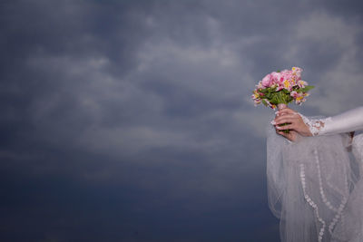 Close-up of woman holding flowers