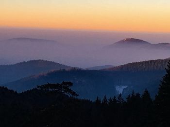 Scenic view of silhouette mountains against sky at sunset