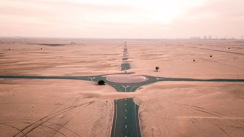 Aerial view of traffic circle at desert against sky during sunset