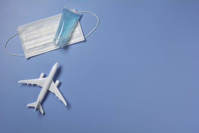 High angle view of airplane on table against blue background