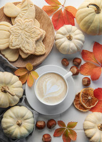 Cozy autumn composition. hot coffee with cookies in a white cup 