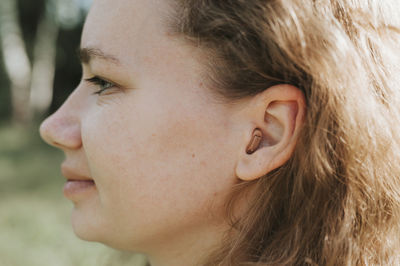 Close-up portrait of beautiful young woman looking away