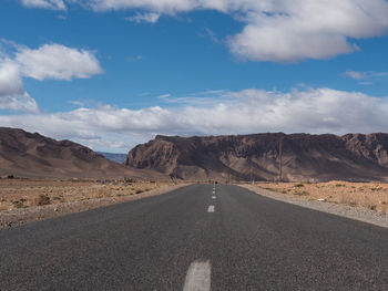 Road amidst rocky desert against sky