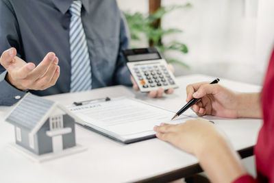 Midsection of businessman working at table