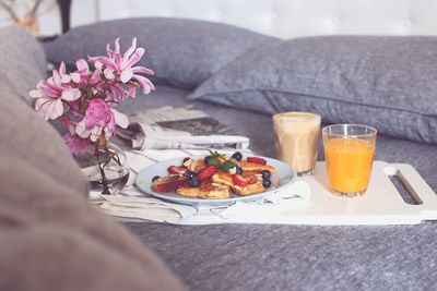 Close-up of breakfast served on bed at home