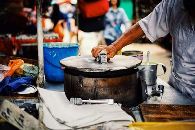 Man preparing food at market stall