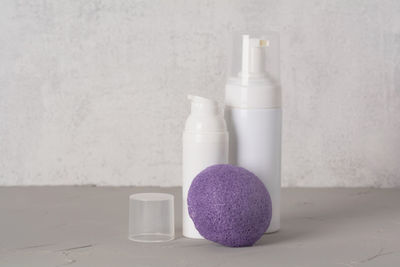 Beauty, spa and wellness concept. facial cosmetic products,konjac sponge on gray texture background.