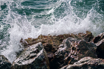 Waves splashing on rocks at shore