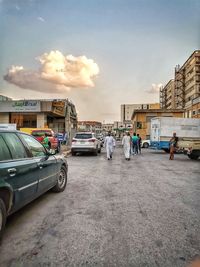 Cars on street against buildings in city