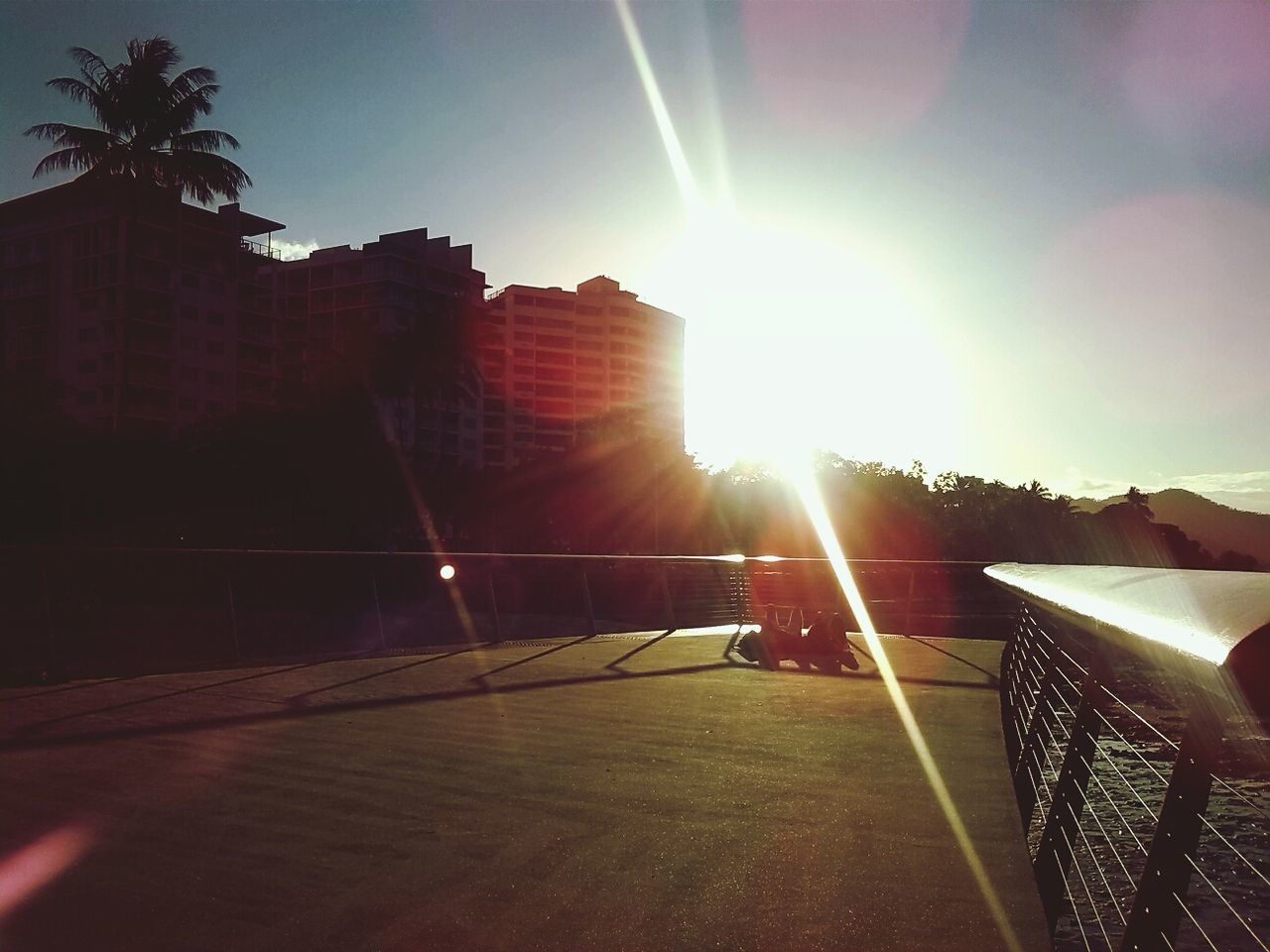 sun, sunbeam, sunlight, lens flare, architecture, built structure, building exterior, sunny, bright, sky, shadow, sunset, city, brightly lit, outdoors, shiny, day, back lit, no people, building