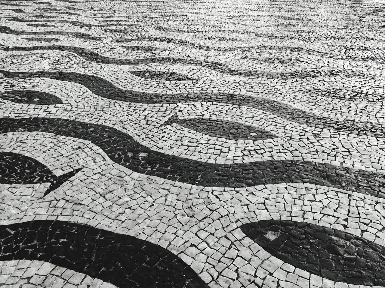 pattern, high angle view, full frame, backgrounds, no people, day, street, cobblestone, design, outdoors, sunlight, footpath, flooring, nature, textured, creativity, city, close-up, curve, paving stone, tiled floor