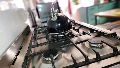 Close-up of kitchen utensils on gas stove