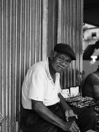 Portrait of mature man selling rings at market