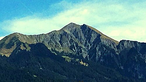 Scenic view of mountains against cloudy sky