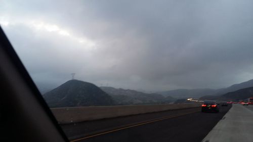 Scenic view of mountains against cloudy sky