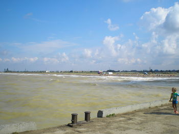 Man on beach against sky