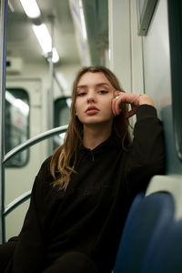 Portrait of young woman traveling in train