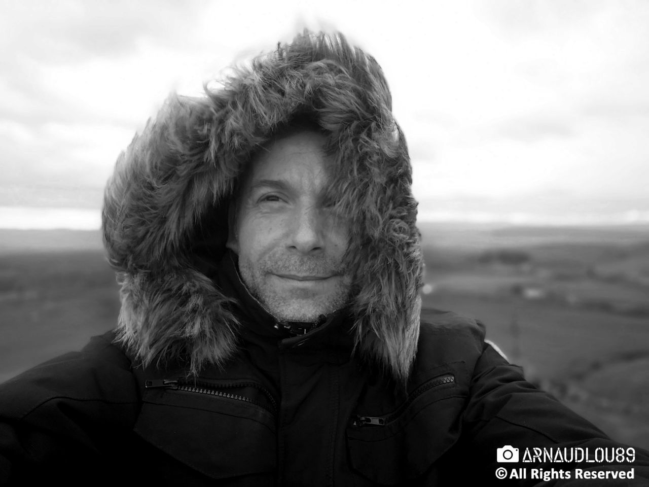 portrait, headshot, warm clothing, clothing, one person, looking at camera, winter, sky, real people, leisure activity, smiling, lifestyles, front view, adult, hood, focus on foreground, young adult, cold temperature, hood - clothing