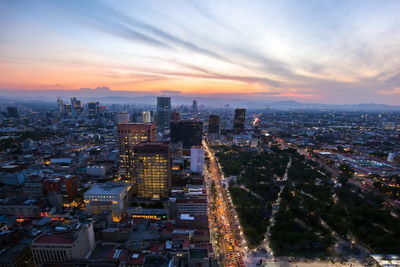 High angle view of illuminated buildings against sky during sunset