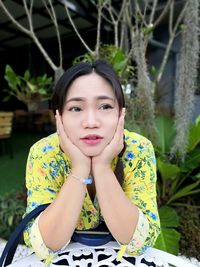 Portrait of woman sitting at table outdoors