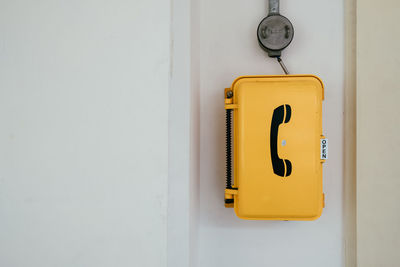 Close-up of pay phone on wall