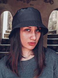 Close-up portrait of young woman wearing hat