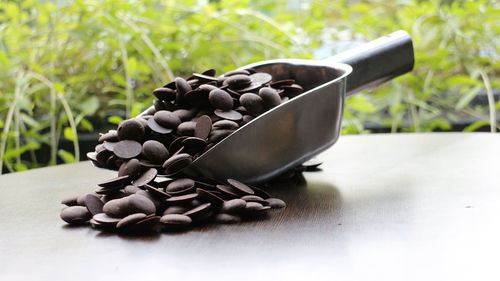 High angle view of chocolate chips in measuring spoon on table