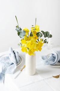 Close-up of flowers in glass against white background