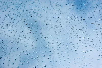 Full frame shot of raindrops on glass window