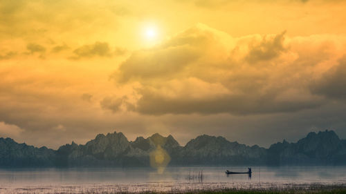 Scenic view of lake against sky during sunset