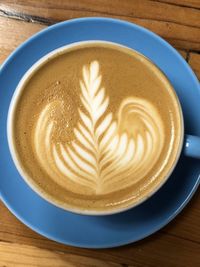 Directly above shot of cappuccino served on table