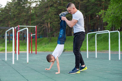 Full length of father with daughter standing outdoors