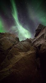 Low angle view of mountain against sky at night