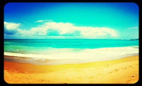 Scenic view of beach against cloudy sky