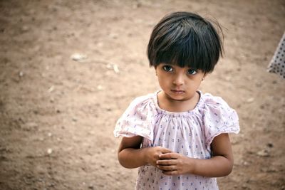 Portrait of cute girl standing outdoors