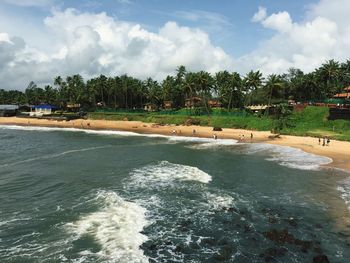 Scenic view of tourists on beach