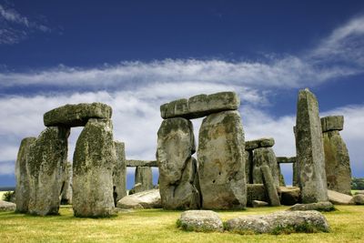 Built structure on landscape against cloudy sky